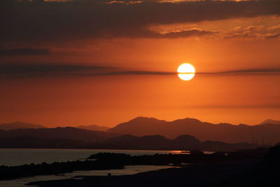 Scenic view of sea against orange sky