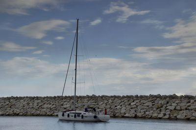 Sailboats sailing on sea against sky