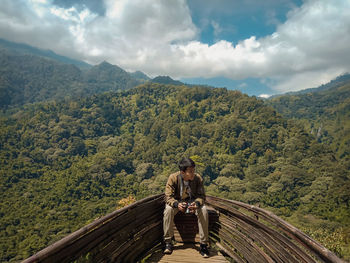 Man on mountain against sky