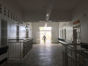 Rear view of people walking in illuminated building