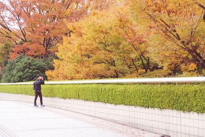 Full length of man walking on road during autumn