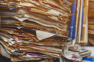 Documents, old papers in folders on shelves are stacked in a mess