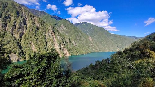 Scenic view of lake and mountains against sky