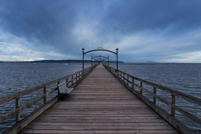 Pier over sea against sky