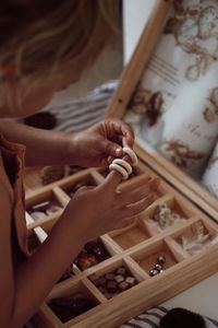 Cropped hands of woman holding chess pieces