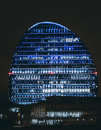 Low angle view of illuminated building against sky at night