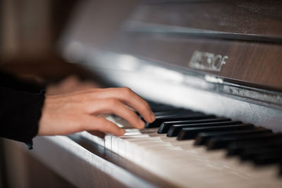 Midsection of man playing piano