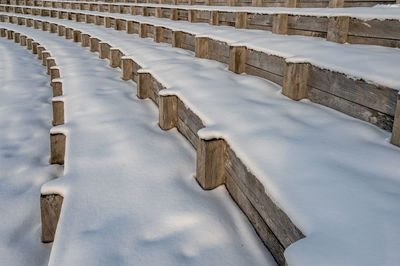 Wooden posts on snow covered land