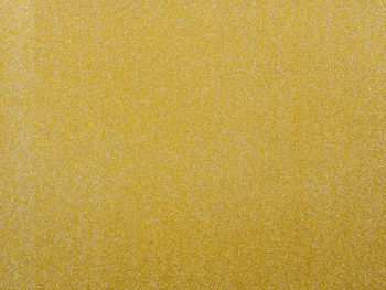 Full frame shot of yellow glittering paper