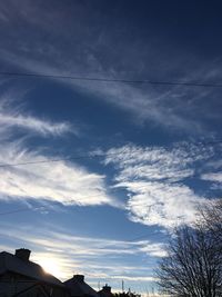 Low angle view of birds flying against sky