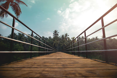 Surface level of footbridge against sky