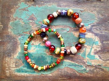 Directly above shot of colorful bead bracelets on wooden table