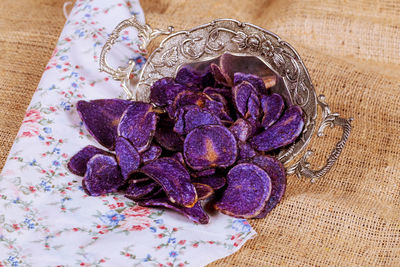 Close-up of fried chips in container on burlap