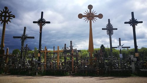 View of cross against cloudy sky