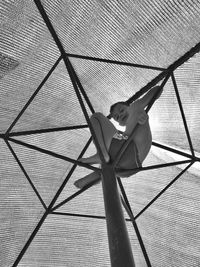 Low angle view of smiling boy sitting in parasol