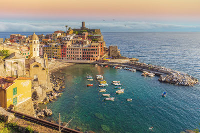 High angle view of buildings by sea against sky