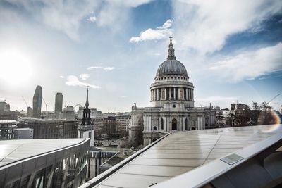 View of cityscape against cloudy sky