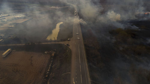 Massive fire, dry grass lanes in fire, firefighters at work, disaster, ecological catastrophe