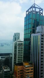 Cityscape against cloudy sky