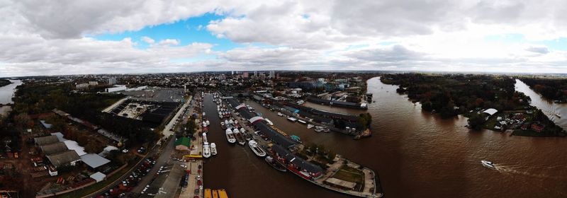 High angle view of crowd amidst buildings in city against sky
