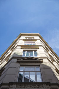 Low angle view of modern building against blue sky