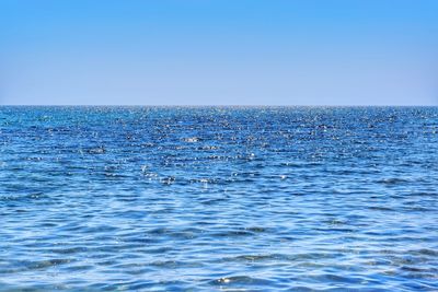 Scenic view of sea against clear blue sky