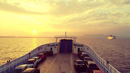 View of cars in ship on sea water at dusk