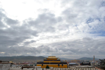 Panoramic view of buildings in city against sky