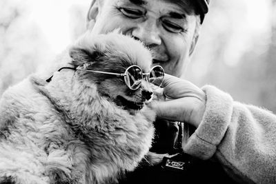 Close-up of man holding dog