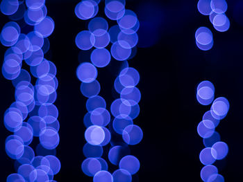 Close-up of blue lights against black background