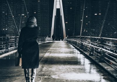 Full length of woman standing on road during rainy season