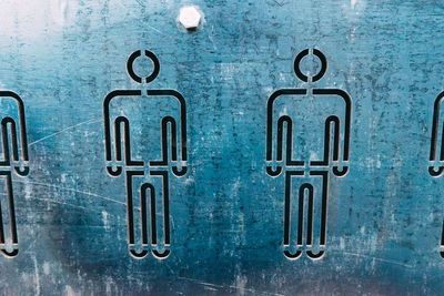 Full frame shot of restroom sign on wall