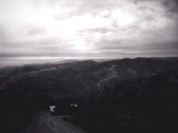 Scenic view of mountains against cloudy sky