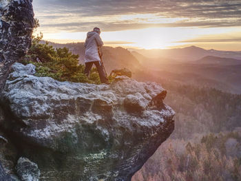 Photographer is taking pictures with camera in morning hills. nature landscape photographer works