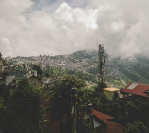High angle view of houses in town against sky