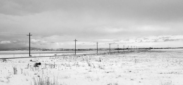 Scenic view of field against sky during winter