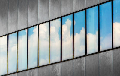 Low angle view of building seen through glass window