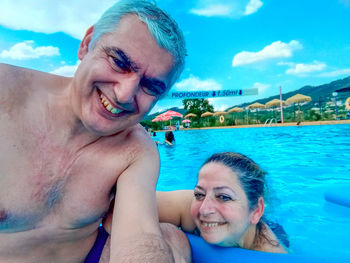 Portrait of smiling young woman in swimming pool