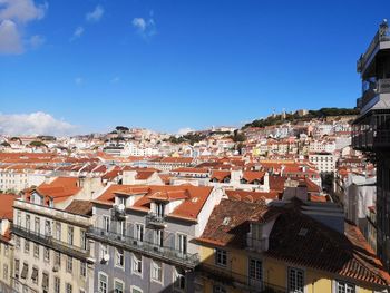 Houses in town against blue sky