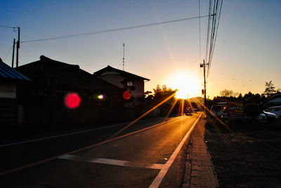 Empty road with buildings in background