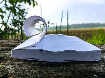 Close-up of open book on field