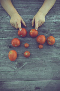 High angle view of hand holding fruit on table