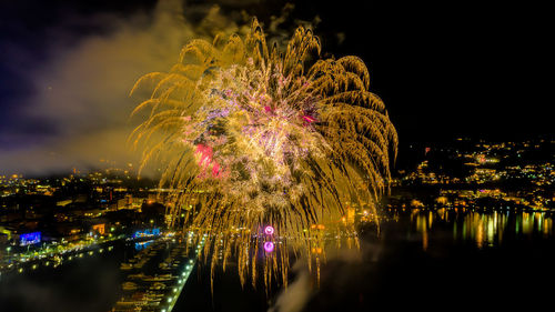 Firework display over river at night