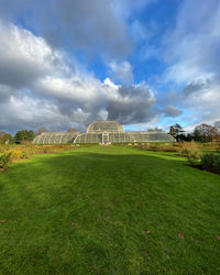 Scenic view of field against cloudy sky