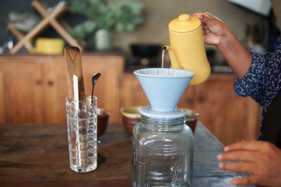 Close-up of hand holding glass of juice