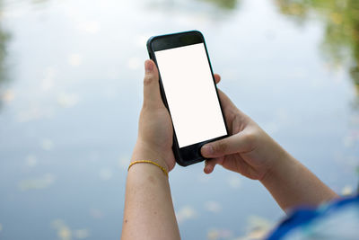 Cropped image of woman holding mobile phone