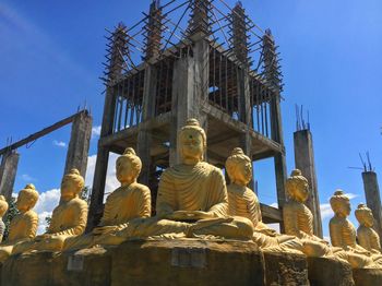 Low angle view of statue against sky