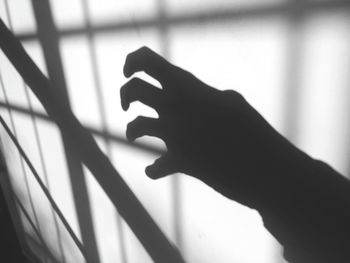 Close-up of hand on shadow