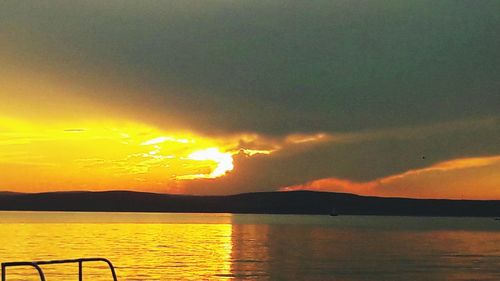 Scenic view of lake against sky during sunset