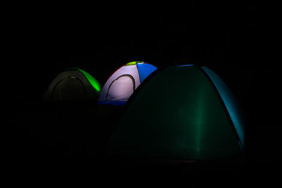 Close-up of illuminated lamp against black background